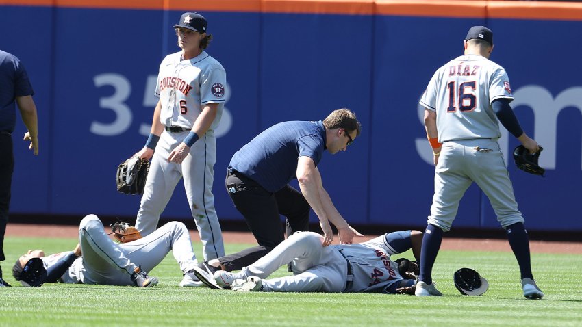 Jeremy Pena #3 crashes into  Yordan Alvarez #44 of the Houston Astros while making a catch hit by Dominic Smith #2 of the New York Mets in the eighth inning as Jake Meyers #6 of the Houston Astros looks on during their game at Citi Field on June 29, 2022 in New York City.