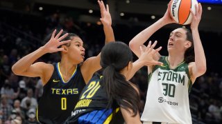 Seattle Storm forward Breanna Stewart (30) puts up a shot against Dallas Wings forward Satou Sabally (0) and guard Briann January (20) during the first half of a WNBA basketball game, Tuesday, July 12, 2022 in Seattle.