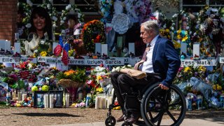 Texas Governor Greg Abbott arrives while US President Joe Biden and First Lady Jill Biden pay their respects at a makeshift memorial outside of Robb Elementary School in Uvalde, Texas on May 29, 2022. - The President and First Lady are in Uvalde to pay their respects following a school shooting.
