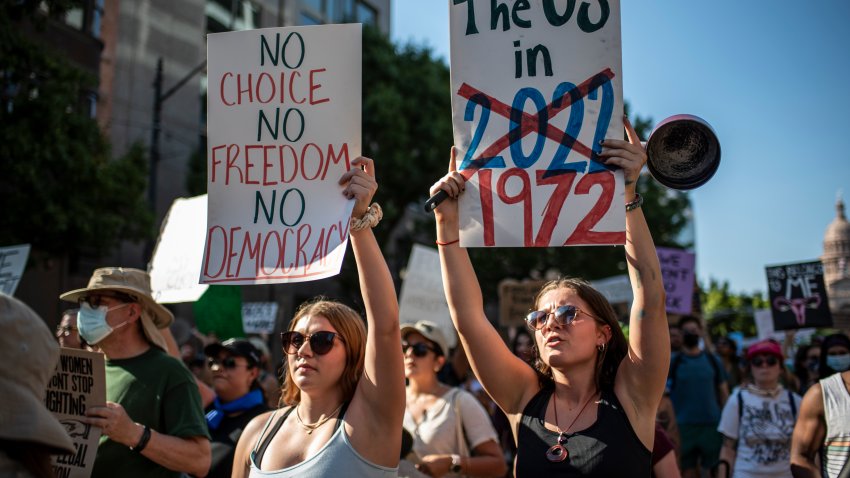 AUSTIN, TX -JUNE 25: Protesters march while holding signs during an abortion-rights rally on June 25, 2022 in Austin, Texas. The Supreme Court’s decision in Dobbs v Jackson Women’s Health overturned the landmark 50-year-old Roe v Wade case and erased a federal right to an abortion. (Photo by Sergio Flores/Getty Images)