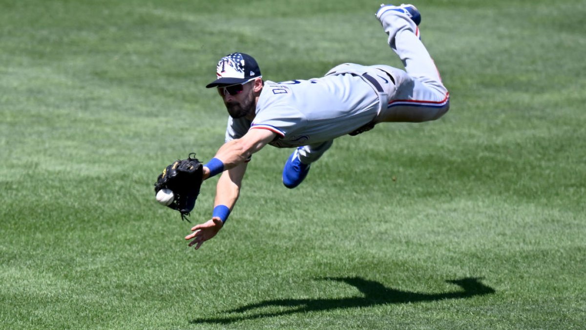 Marcus Semien of the Texas Rangers blows a bubble in the sixth inning  News Photo - Getty Images