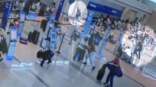 The Dallas Police Department on Tuesday released images from inside Love Field Airport showing an armed woman opening fire inside the check-in area and police responding.