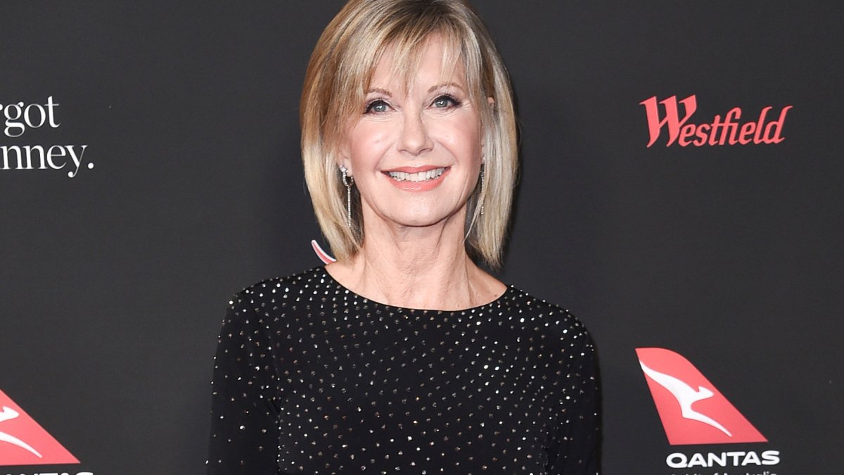 Exclusive: Olivia Newton-John’s Widower Says He Continues to ‘Speak to Her Out Loud’
