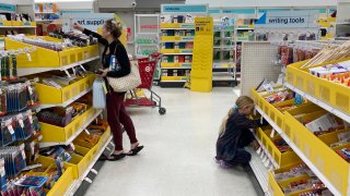 A parent shops for school supplies deals at a Target store