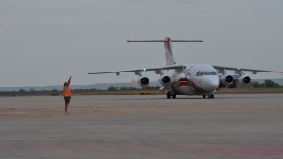 A plane returns to the Abilene airport after fighting fires in Texas.