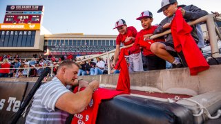 Infielder Josh Jung of the Texas Rangers and formerly of the Texas Tech Red Raiders signs autographs at halftime of the college football game against the Iowa State Cyclones at Jones AT&T Stadium on November 13, 2021 in Lubbock, Texas.