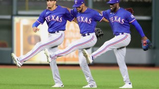 Leody Taveras #3, Adolis Garcia #53, and Bubba Thompson #65 of the Texas Rangers celebrate their 4-3 win over the Houston Astros at Minute Maid Park on September 06, 2022 in Houston, Texas.
