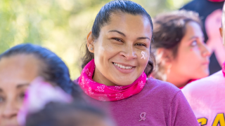 Woman in crowd wearing pink at Making Stride