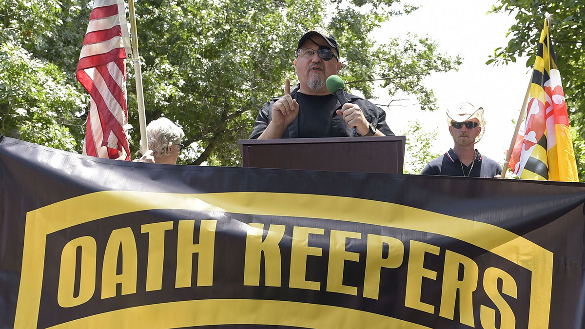 FILE - Stewart Rhodes, founder of the Oath Keepers, center, speaks during a rally outside the White House in Washington, June 25, 2017.