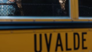 FILE - The American Flag is reflected in the window of a Uvalde CISD School Bus on June 24, 2022, in Uvalde, Texas.