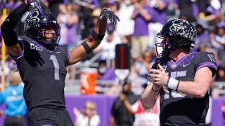 TCU quarterback Max Duggan (15) and teammate Quentin Johnston (1) celebrate Duggan's touchdown against Oklahoma during the second half of an NCAA college football game Saturday, Oct. 1, 2022, in Fort Worth, Texas. TCU won 55-24.
