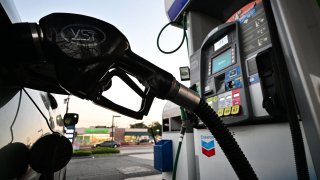 A nozzle pumps gasoline into a vehicle at a gas station in Los Angeles, California on October 5, 2022. Saudi Arabia will reduce how much oil it sends to the global economy. (Photo by FREDERIC J. BROWN/AFP via Getty Images)