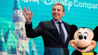 Chief executive officer and chairman of The Walt Disney Company Bob Iger and Mickey Mouse look on before ringing the opening bell at the New York Stock Exchange, November 27, 2017 in New York City.