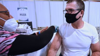 A health worker administers a dose of Pfizer covid-19 vaccine to a man at the Sanford Civic Center. With the emergence of the Omicron covid-19 variant in numerous countries, including the United States, the US Centers for Disease Control (CDC) encouraged all vaccinated adults to receive their Covid-19 booster shot.