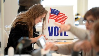 Amalia Conner registers to vote so she can cast her ballot in midterm elections at the Bay Ridge Civic Association in Annapolis, November 8, 2022.