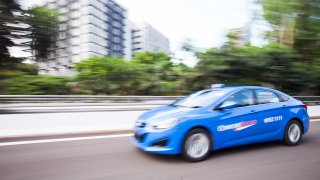 A ComfortDelGro Corp. taxi travels along an expressway in Singapore