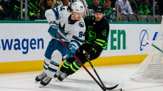 DALLAS, TX – NOVEMBER 11: San Jose Sharks left wing Alexander Barabanov (94) and Dallas Stars defenseman Miro Heiskanen (4) chase the puck during the game between the Dallas Stars and the San Jose Sharks on November 11, 2022 at American Airlines Center in Dallas, Texas.