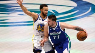 Luka Doncic #77 of the Dallas Mavericks handles the ball as Stephen Curry #30 of the Golden State Warriors defends in the first half at American Airlines Center on November 29, 2022 in Dallas, Texas.