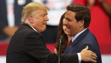 ESTERO, FL - OCTOBER 31:  President Donald Trump greets Florida Republican gubernatorial candidate Ron DeSantis during a campaign rally at the Hertz Arena on October 31, 2018 in Estero, Florida. President Trump continues traveling across America to help get the vote out for Republican candidates running for office.  (Photo by Joe Raedle/Getty Images)