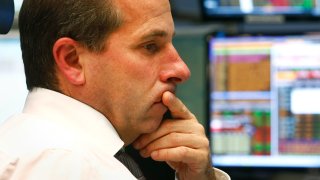 A trader works at Frankfurt’s stock exchange.