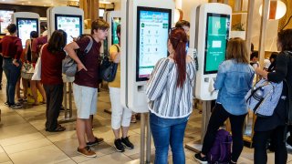 McDonald’s crowds at self-service kiosk.