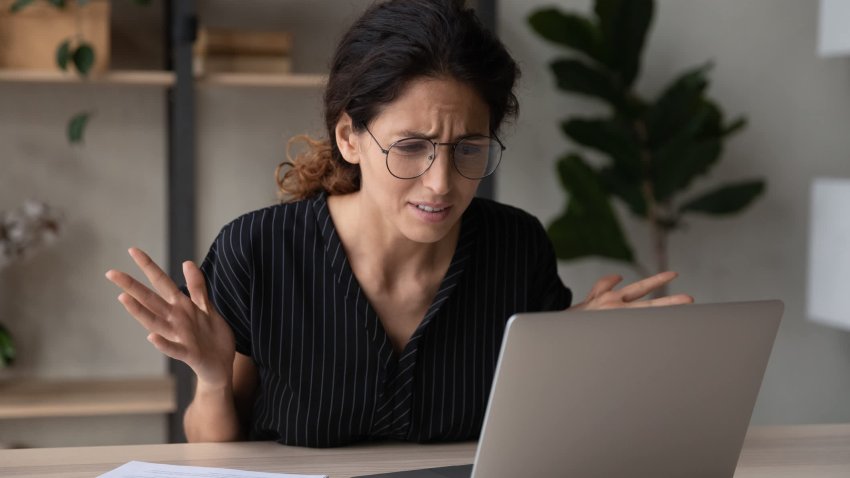 Close up upset businesswoman in glasses having problem with laptop, broken or discharged device, confused unhappy woman looking at computer screen, reading bad news, unexpected debt or spam