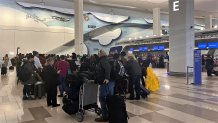 Travelers stand in line for service from Southwest Airlines at New York City's LaGuardia Airport on Tuesday, December 27, 2022, after a significant series of cancelations by the carrier.