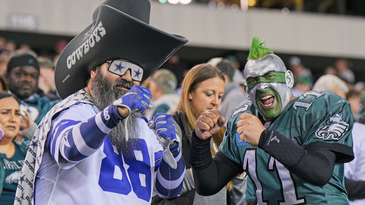 A Cowboys fan fights Eagles fan in the stands