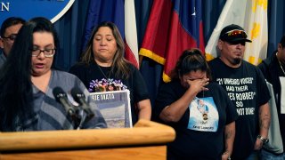 Felicia Martinez, mother of Xavier Lopez who was killed by a gunman at Robb Elementary School in Uvalde, Texas, center tries to hold back tears as she and other surviving family members attend a news conference at the Texas Capitol.