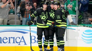 Radek Faksa #12 of the Dallas Stars is congratulated by Esa Lindell #23 and Fredrik Olofsson #42 after Faksa scored a goal during the first period against the Arizona Coyotes at American Airlines Center on January 21, 2023 in Dallas, Texas.
