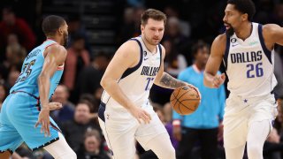 Luka Doncic #77 of the Dallas Mavericks handles the ball against Mikal Bridges #25 of the Phoenix Suns during the first half of the NBA game at Footprint Center on January 26, 2023 in Phoenix, Arizona.