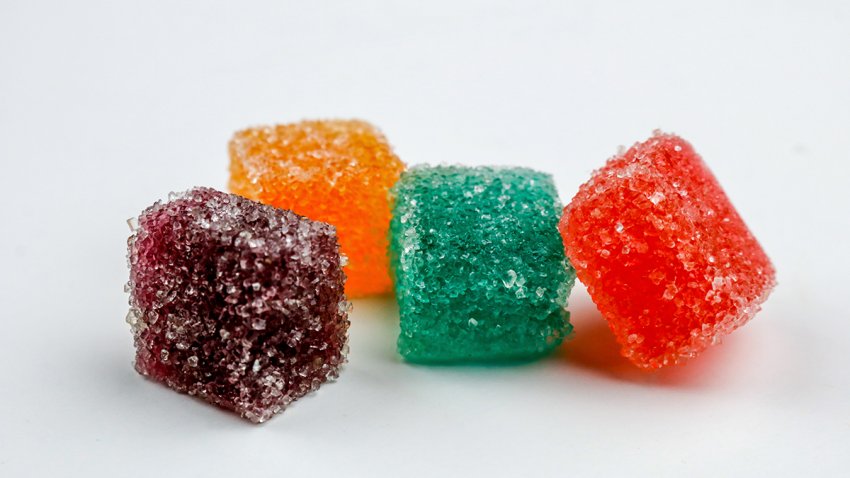 Vibrant colored marijuana gummy candies set on a white background