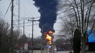 A black plume rises over East Palestine, Ohio, as a result of a controlled detonation of a portion of the derailed Norfolk Southern Monday, Feb. 6, 2023.