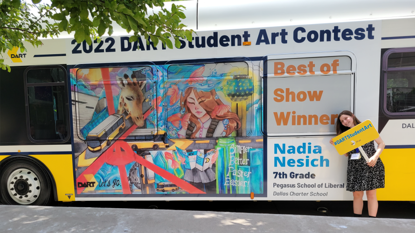 Nadia Nesich, the winner of the 2022 DART Student Art Contest next to a DART bus displaying her winning artwork.