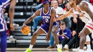 Forward Emanuel Miller #2 of the TCU Horned Frogs handles the ball during the first half of the college basketball game against the Texas Tech Red Raiders at United Supermarkets Arena on February 25, 2023 in Lubbock, Texas.
