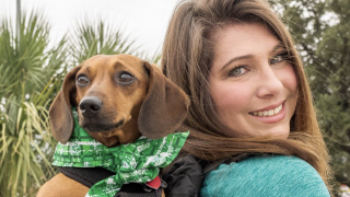 woman and dog wearing green at the North Texas Irish Festival