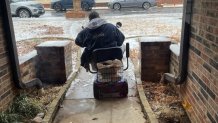 Jeff Coben on his motorized chair clearing his neighbors walkway.