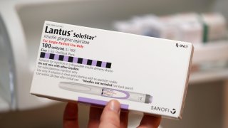 A pharmacist holds a box of the drug Lantus SoloStar, made by Sanofi Pharmaceutical, at a pharmacy in Provo, Utah, January 9, 2020.