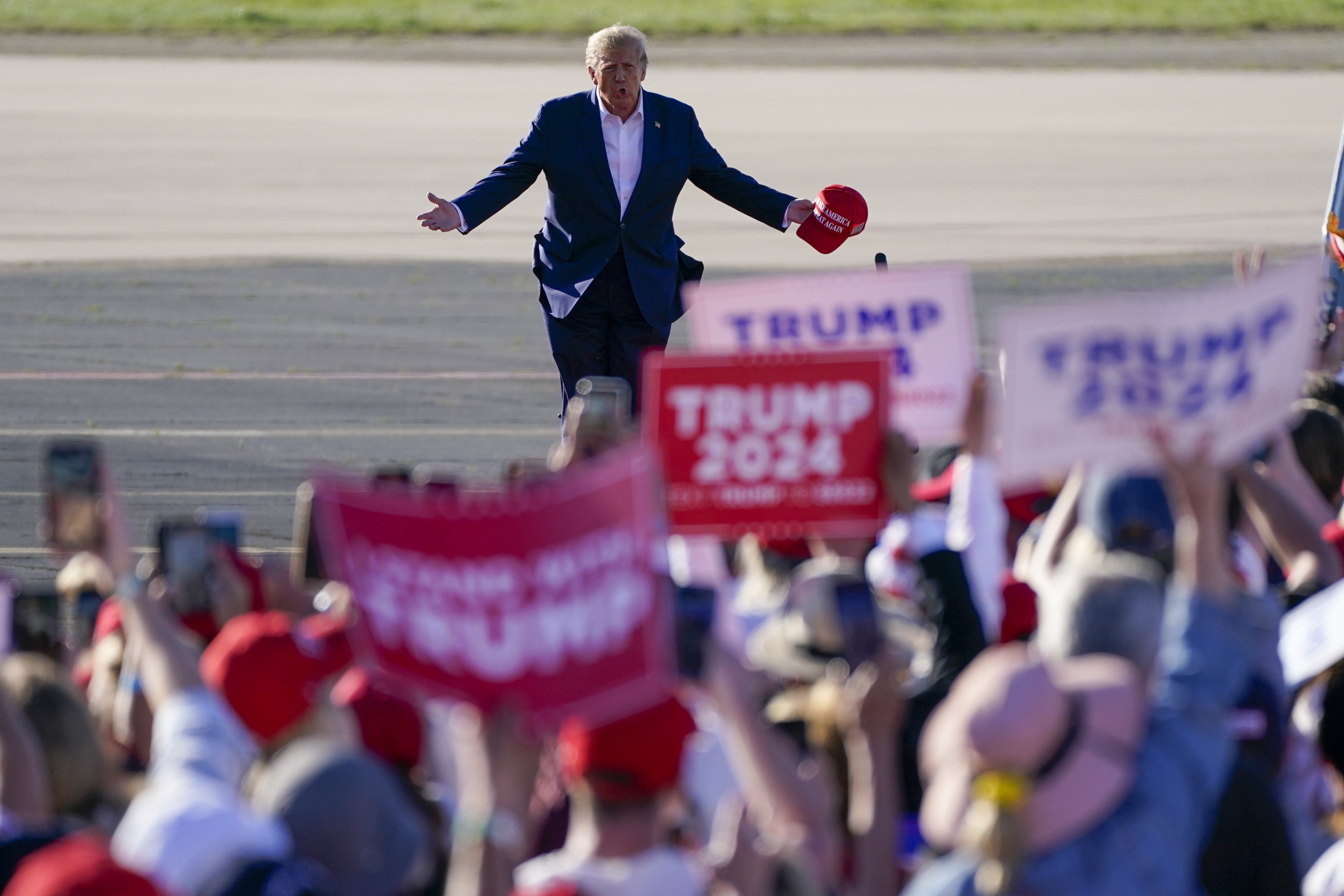 Former President Donald Trump walks across the tarmac as he arrives to speak at a campaign rally at Waco Regional Airport Saturday, March 25, 2023, in Waco, Texas.