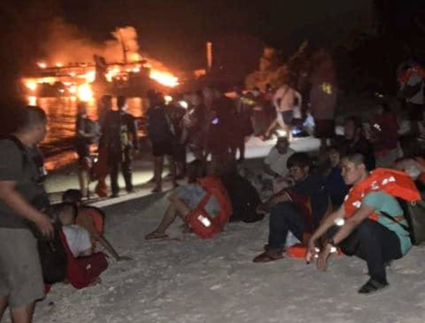 In this photo provided by the Philippine Coast Guard, survivors rest after being rescued from the still burning MV Lady Mary Joy at Basilan, southern Philippines early Thursday March 30, 2023.