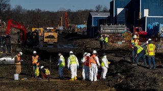 File - Contractors collect soil and air samples from the derailment site on March 9, 2023, in East Palestine, Ohio.