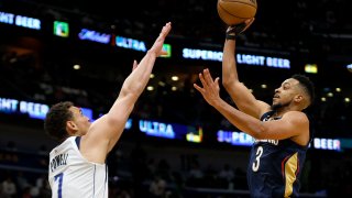 NEW ORLEANS, LOUISIANA – MARCH 08: CJ McCollum #3 of the New Orleans Pelicans shoots over Dwight Powell #7 of the Dallas Mavericks during the second quarter of an NBA game at Smoothie King Center on March 08, 2023 in New Orleans, Louisiana.