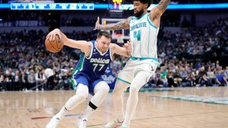 Luka Doncic #77 of the Dallas Mavericks controls the ball as Nick Richards #4 of the Charlotte Hornets defends during the second half at American Airlines Center on March 24, 2023 in Dallas, Texas.