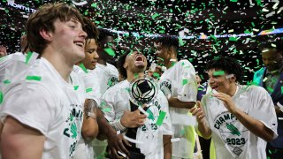 Kai Huntsberry #10 of the North Texas Mean Green celebrates with the trophy after the team’s 68-61 victory over the UAB Blazers to win the NIT basketball tournament at the Orleans Arena on March 30, 2023 in Las Vegas, Nevada.