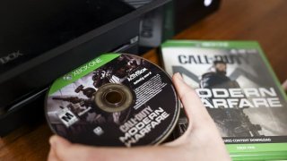 An Activision Blizzard’s Call of Duty: Modern Warfare video game is inserted into the Microsoft’s Xbox One video game console arranged in Denver, Colorado, on Wednesday, Jan. 19, 2022.