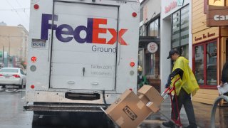 A FedEx delivery man is seen on Chestnut Street in San Francisco on January 11, 2023 as atmospheric river storms hit California, United States.
