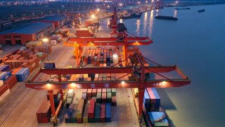 Aerial photo shows the night operation of Suqian Port in Suqian city, East China’s Jiangsu province, March 26, 2023.