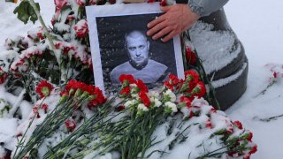 A portrait of Russian military blogger Vladlen Tatarsky, (real name Maxim Fomin), who was killed in the cafe explosion the day before, is placed among flowers near the blast site in Saint Petersburg, Russia April 3, 2023. 
