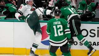 Minnesota Wild's Jonas Brodin (25) is knocked into the boards by Dallas Stars' Ty Dellandrea (10) as Radek Faksa (12) looks on in the third period of Game 1 of an NHL hockey Stanley Cup first-round playoff series, Monday, April 17, 2023, in Dallas.