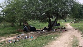 Makeshift tents and debris are seen at a migrant camp in Matamoros, Mexico, Friday, April 21, 2023. About two dozen makeshift tents in the area were set ablaze and destroyed, across the border from Texas this week, witnesses said.